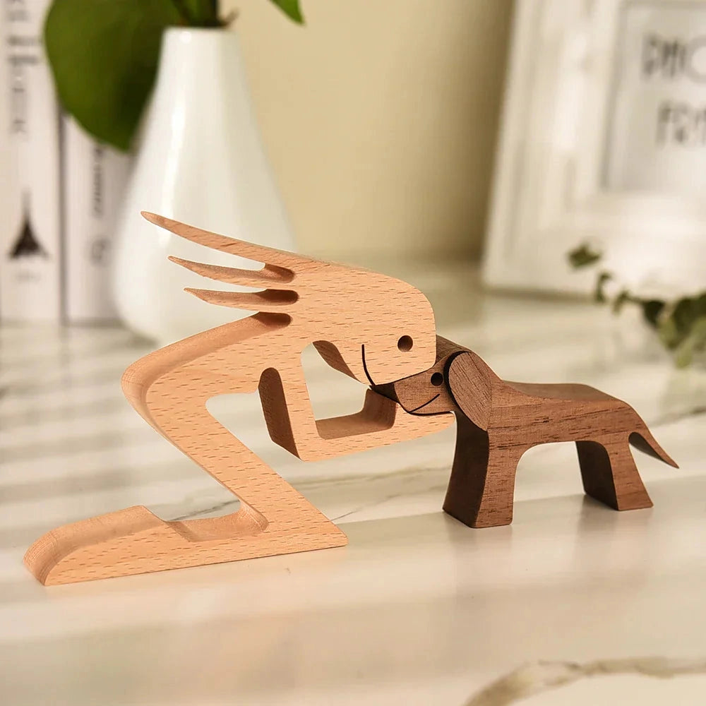 Wooden dog sculpture with a striped scarf, resembling a fawn, crafted from natural hardwood, displayed on a table as a festive holiday figurine.