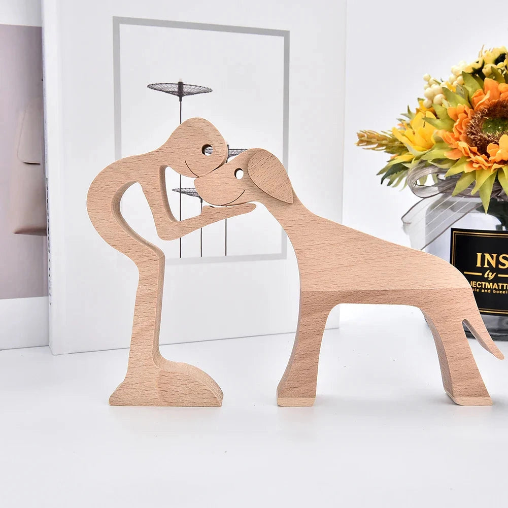 Wooden dog sculpture wearing a striped scarf, positioned in a festive setting with wooden elements and decorative plants in the background.