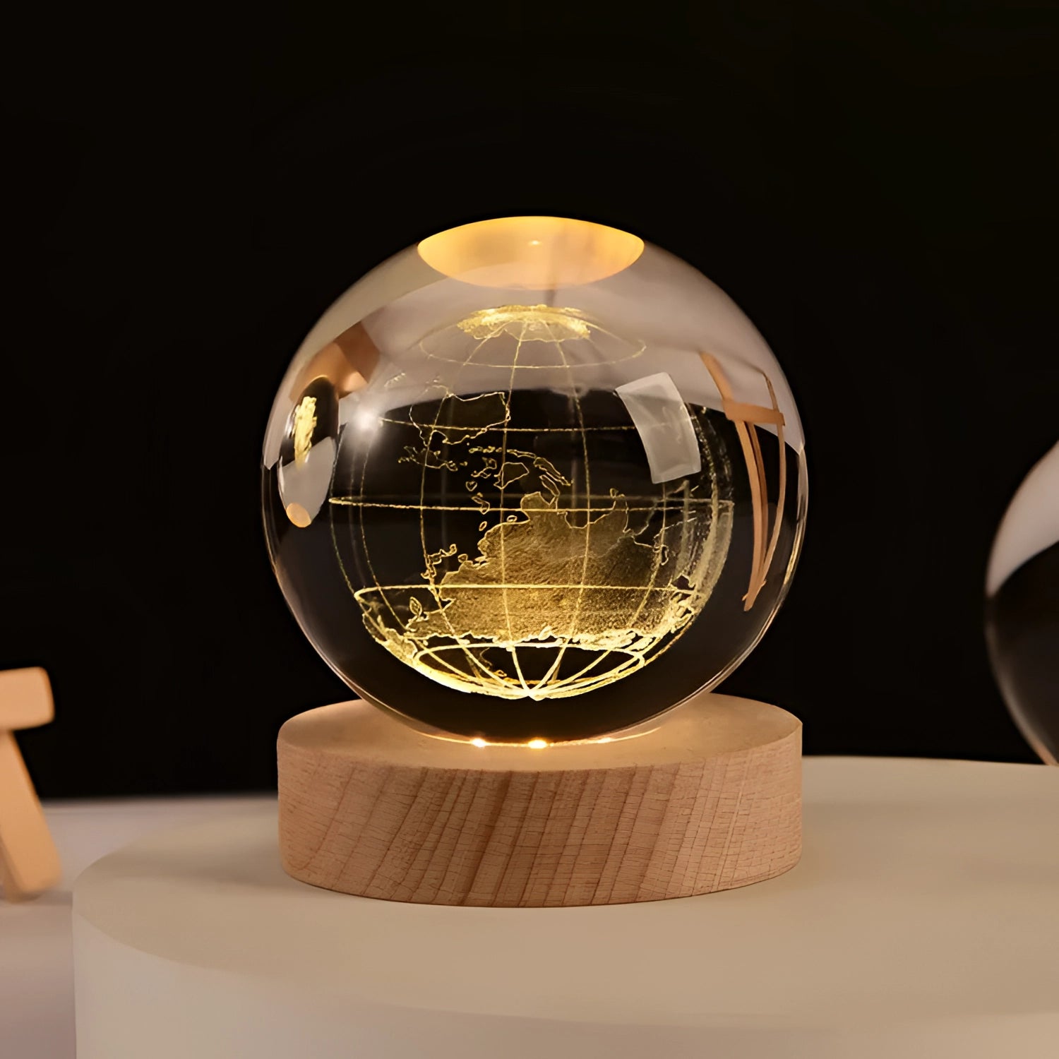 Portable eco-friendly wooden USB aroma diffuser with a globe-shaped design, resembling a world map etched on its surface.