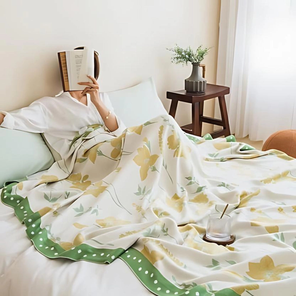 Yellow flower cooling blanket made of luxury cotton, designed as a botanical bedspread, shown in a 200x230cm size with a floral pattern, draped neatly over a bed.