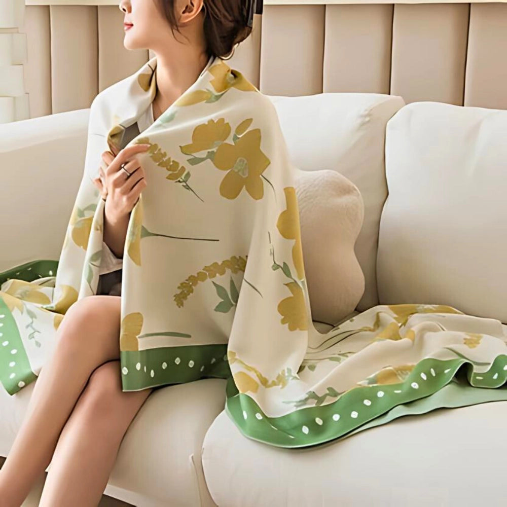 A luxurious yellow botanical-themed cooling blanket made from cotton, displayed neatly on a bed, showcasing its elegant design and soft texture.