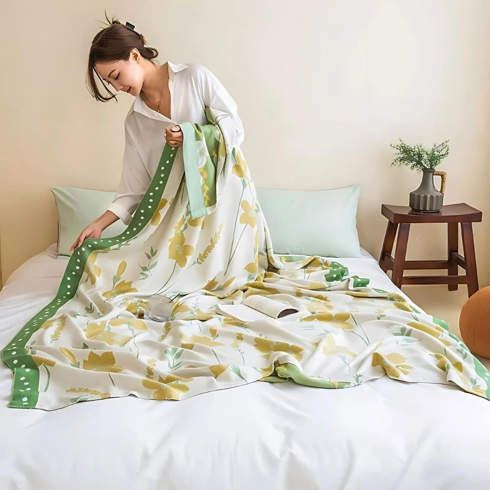 Yellow flower cooling blanket made of luxury cotton, designed with a botanical pattern, elegantly spread out on a bed, showcasing its vibrant floral motif and soft, comfortable fabric perfect for adding a touch of nature to bedroom decor.