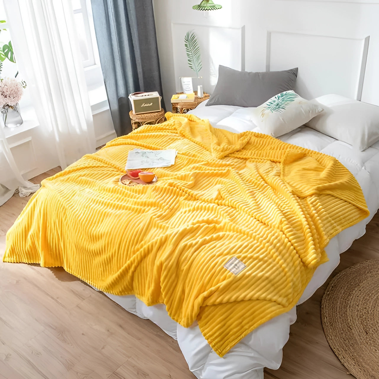 Yellow ribbed blanket draped over a modern bedroom setting, showcasing its vibrant color and cozy texture, with elements of amber and gold tones in the surrounding interior design.