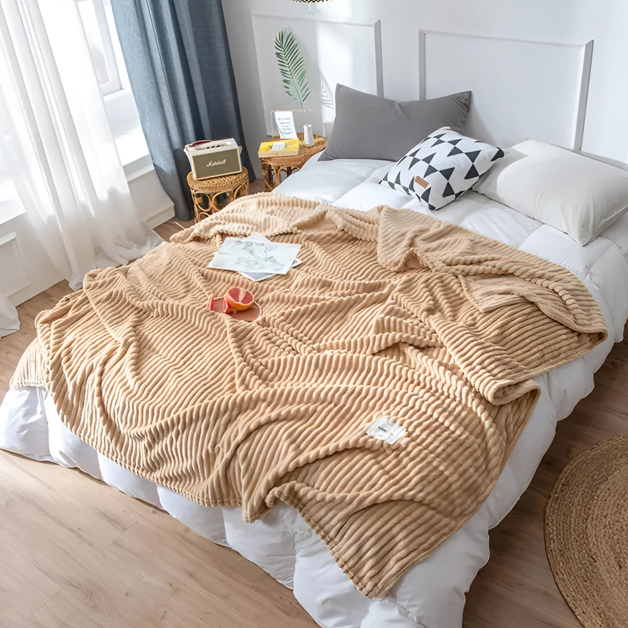 A cozy yellow ribbed blanket is draped over a modern bed with a wooden frame, accompanied by pillows, enhancing the comfort and interior design of the bedroom space.